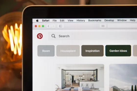 Laptop displaying a Pinterest feed on a desk